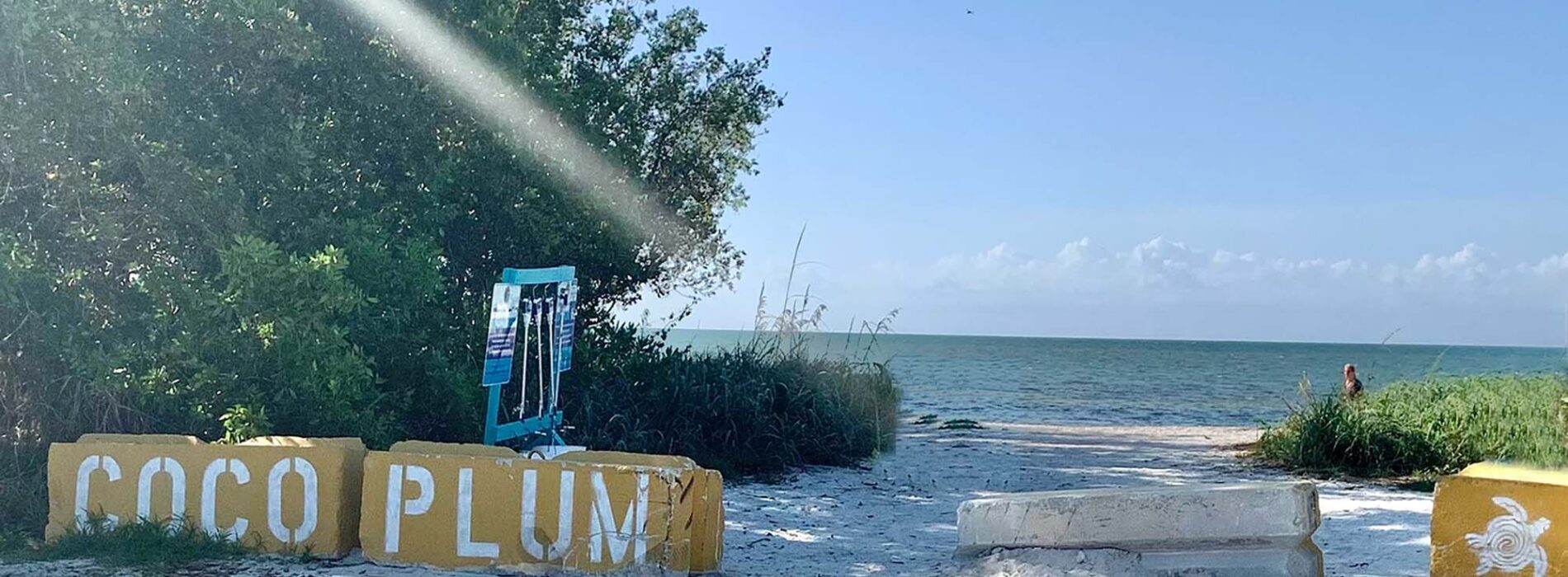 Entrance to Coco Plum Beach with name written on stones